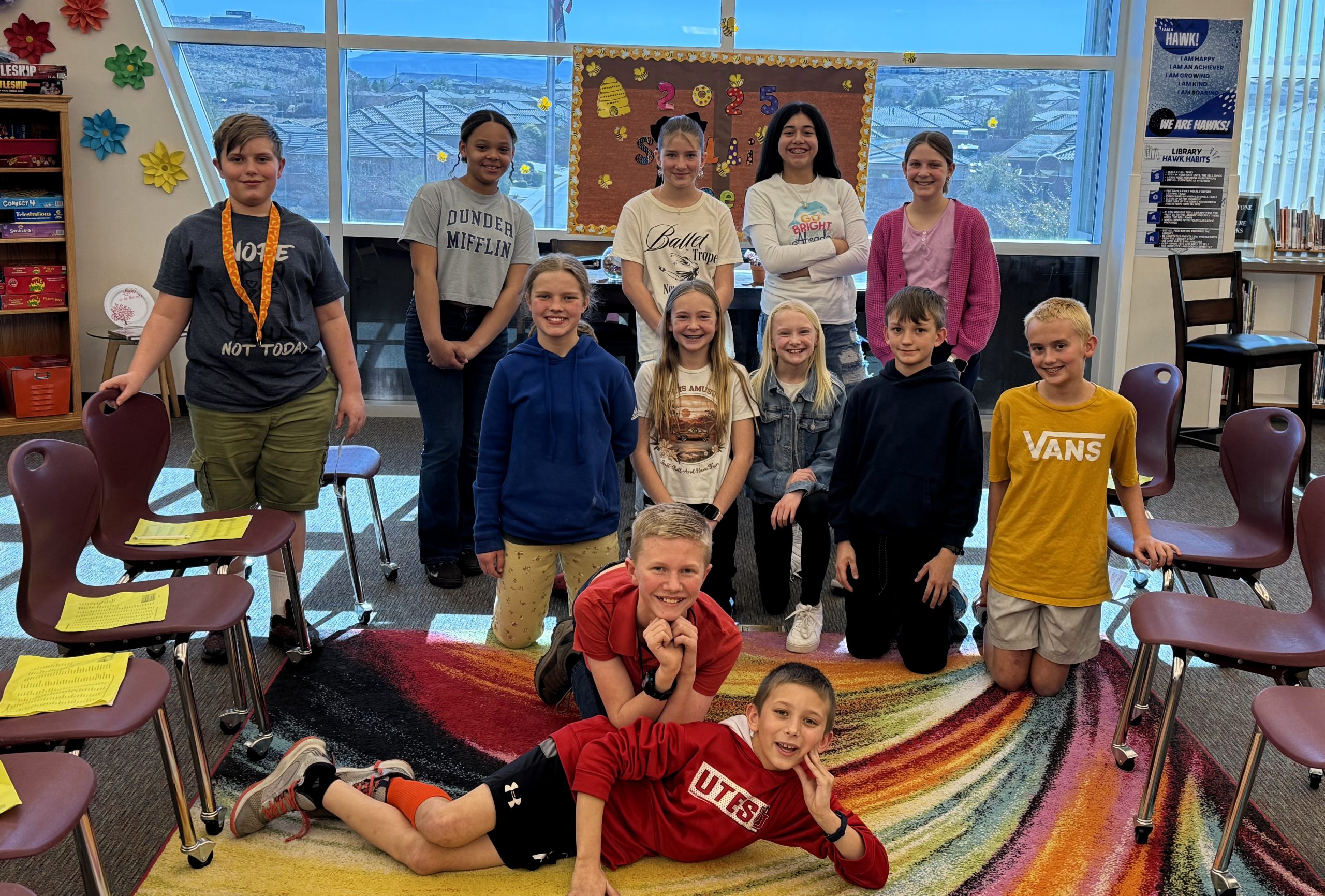 12 students pose for a quick picture before the annual spelling bee in the library