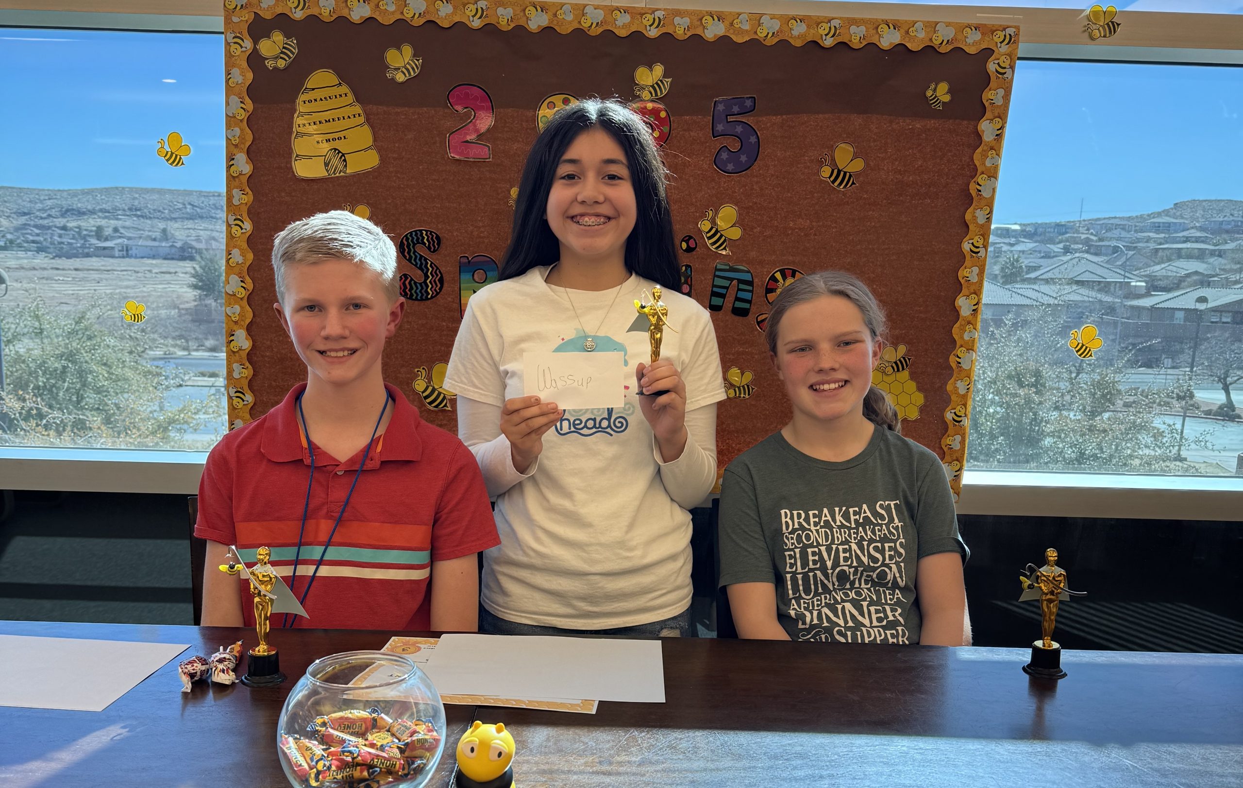 Top three finishers in the spelling bee take time for a quick picture in the library