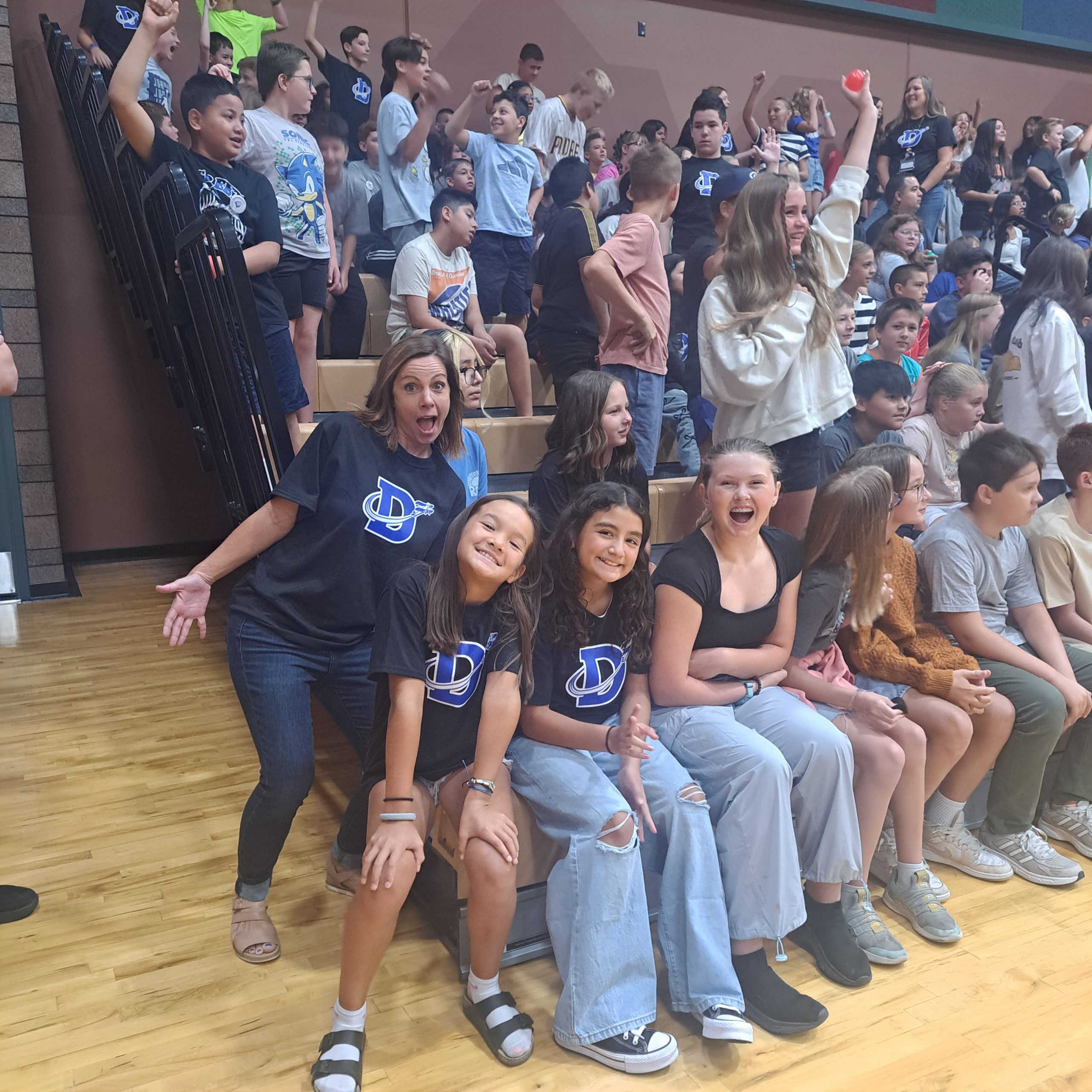 Ms. Kolodziej with several students at the first DIS spirit assembly.
