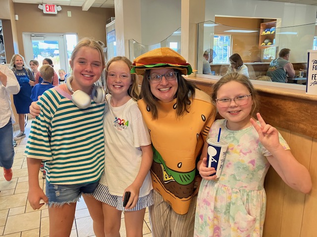 Ms. Wiser with three female students supporting DIS Culver's Night
