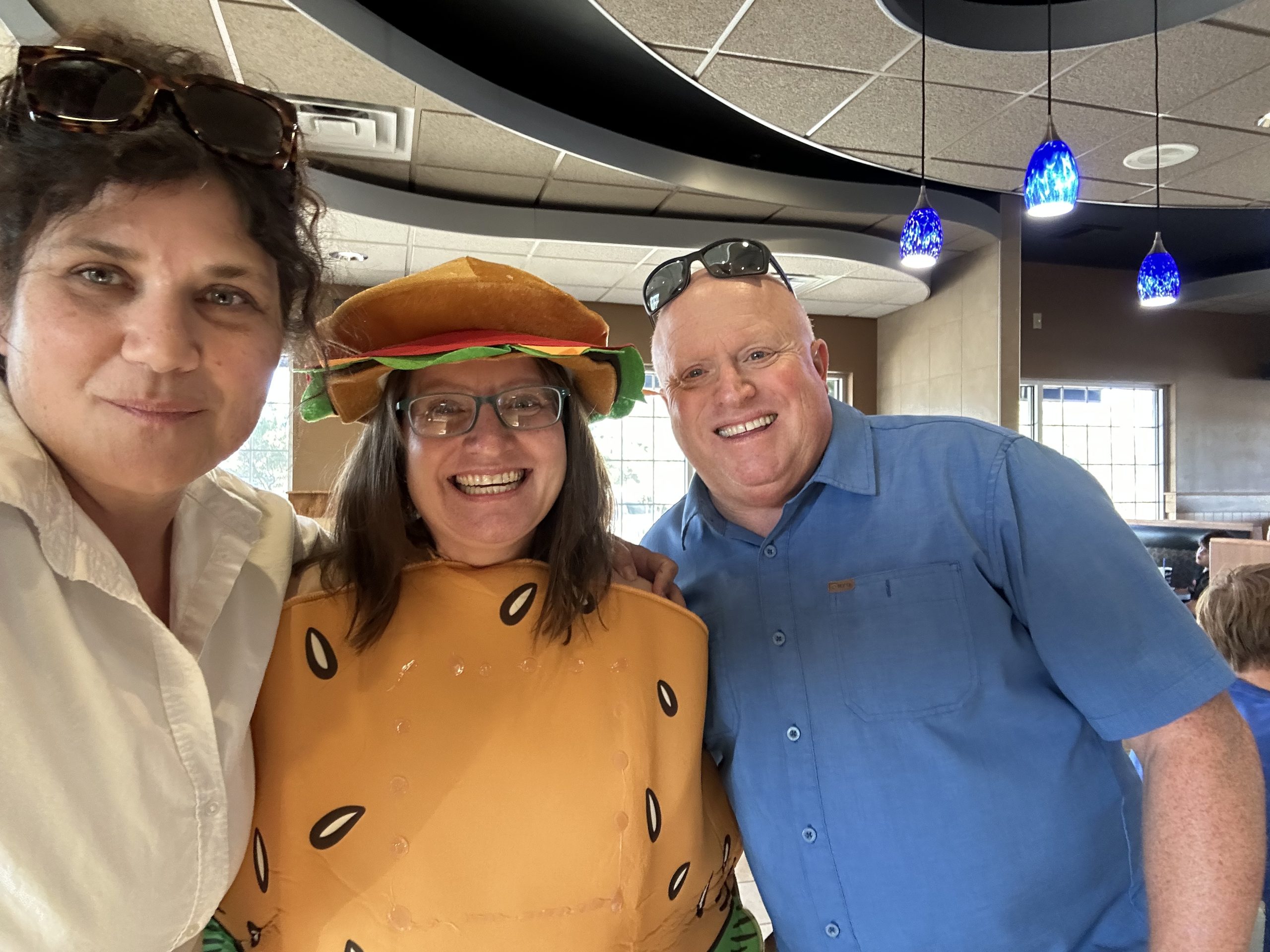 Ms. Webb, Ms. Wiser (in her hamburger costume), and Mr. White supporting the PTA during Culver's Night.